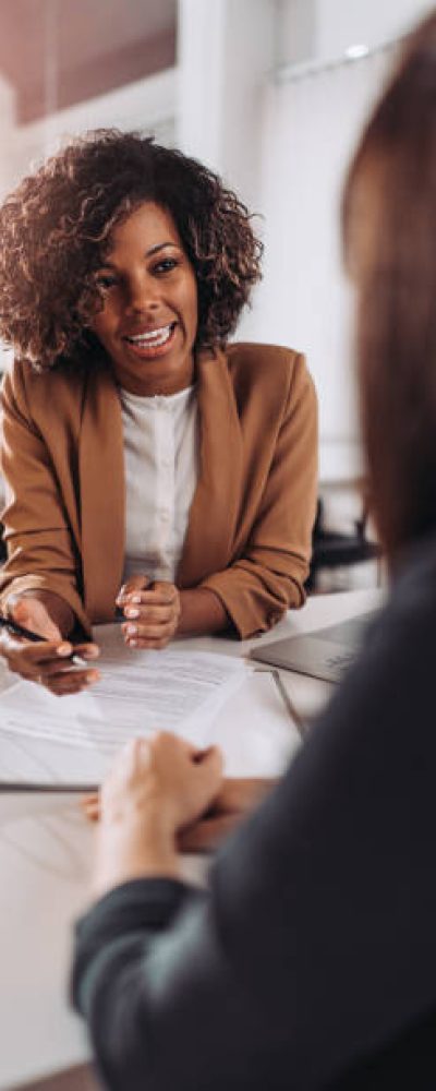 Young woman doing a job interview in the office and talking with client